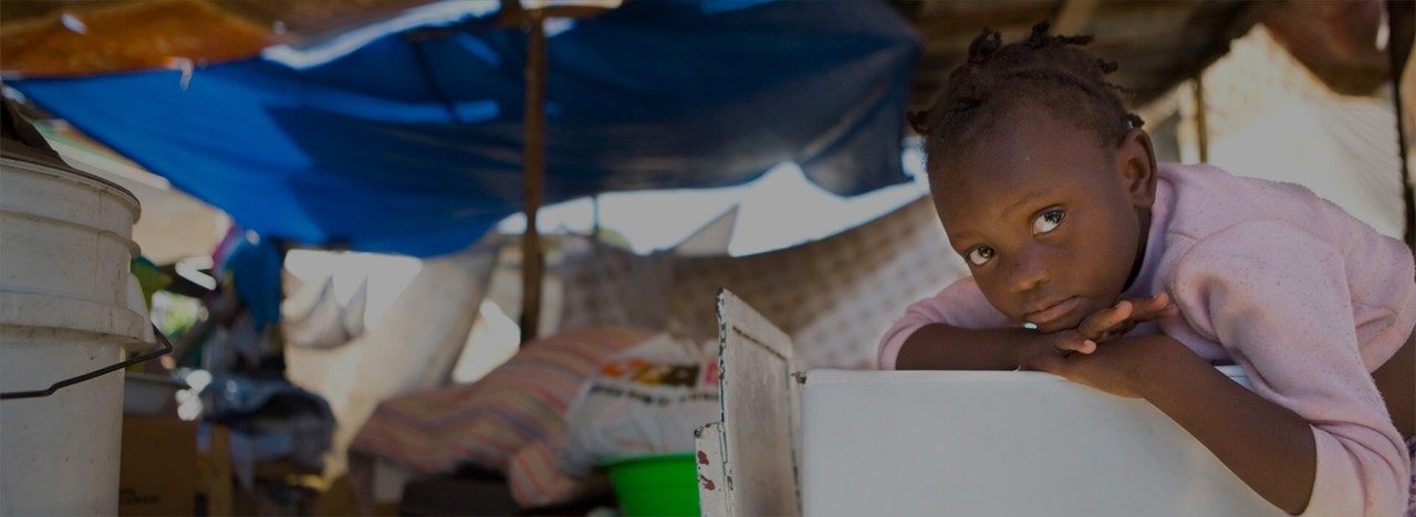 Child in a makeshift tent.