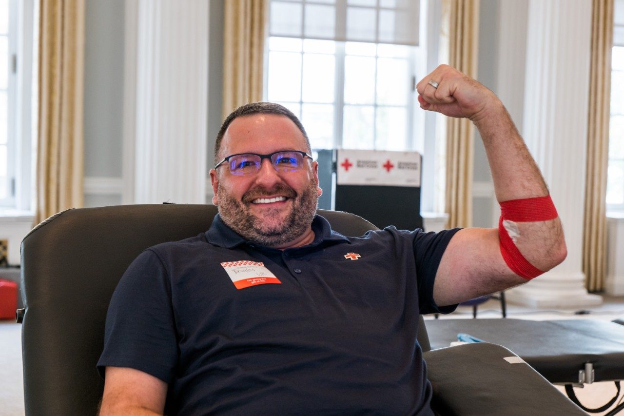 red cross worker drawing blood from person