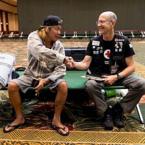 red cross client shaking hand of rich byam.