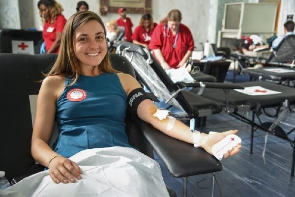 Woman sitting in chair donating blood.