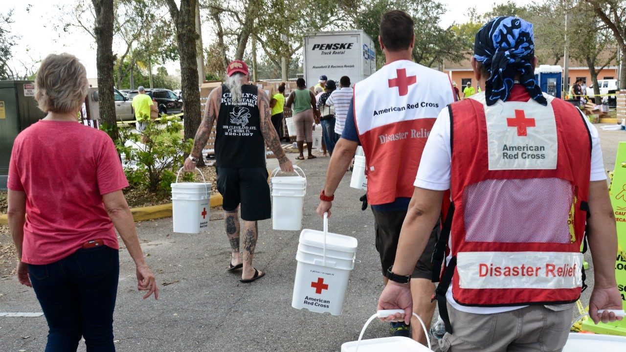 volunteers carrying buckets