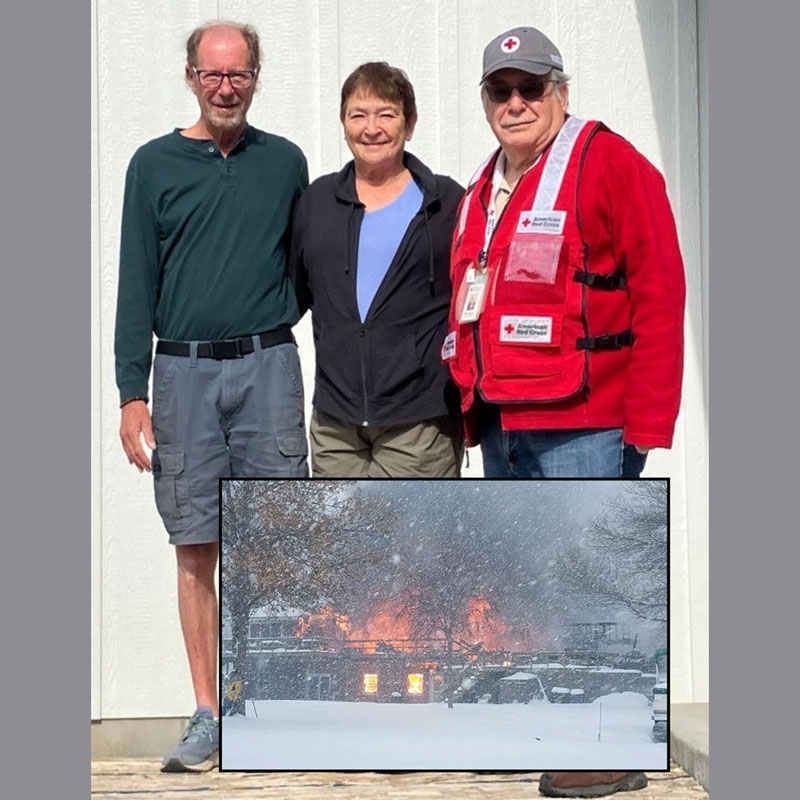 Tom Goebel, Helen Goebel and Mike Hofmann with picture of house in the snow on fire.