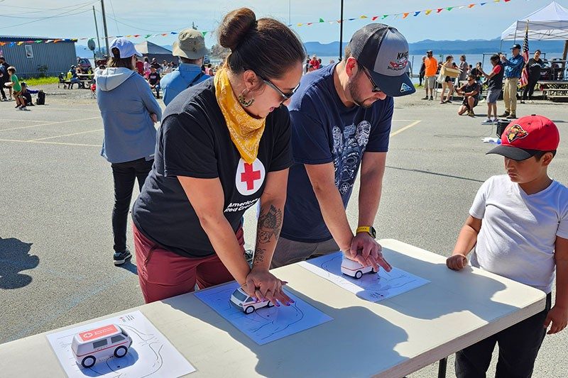 Students in a Red Cross CPR class practicing on a American Red Cross shaped van stress ball.
