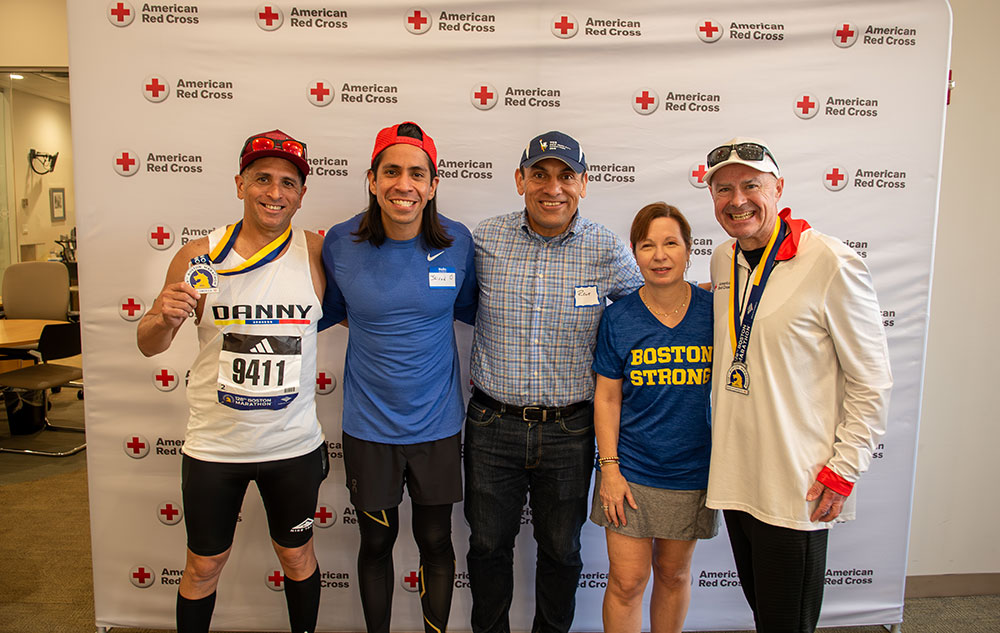 Group shot of marathon runners showing medals.