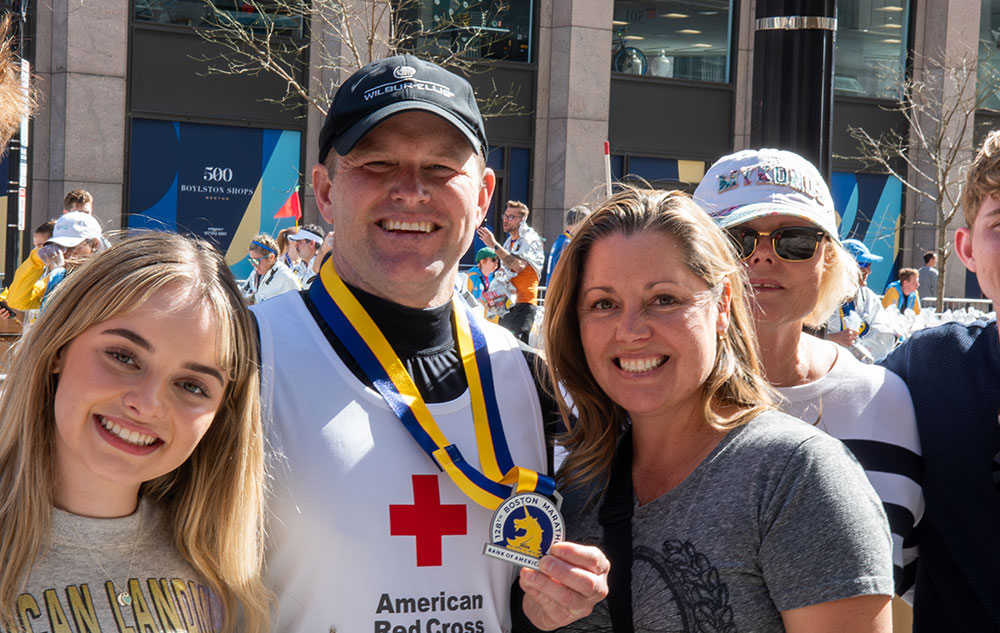 Marathon runner showing medal.