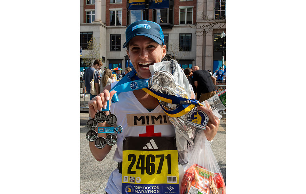Marathon runner showing medals.