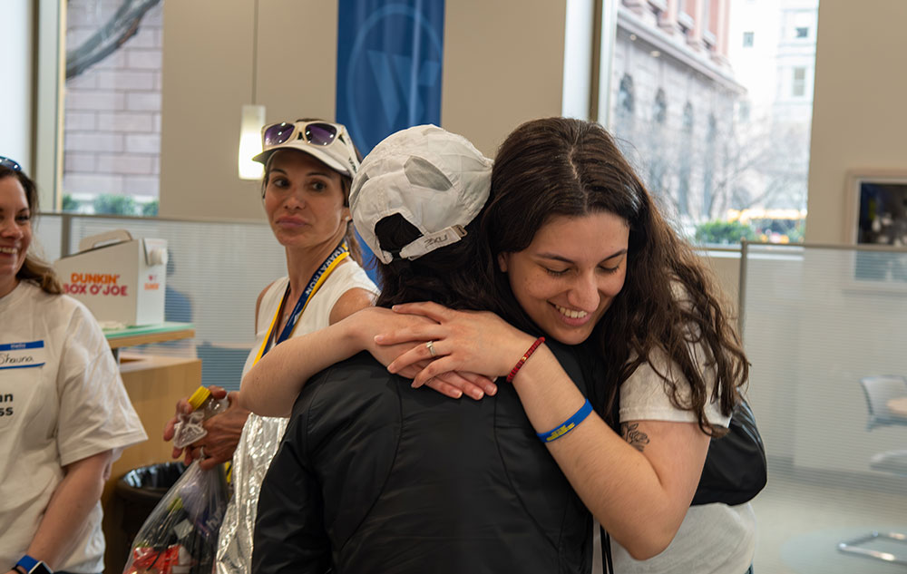 Two people hugging each other.