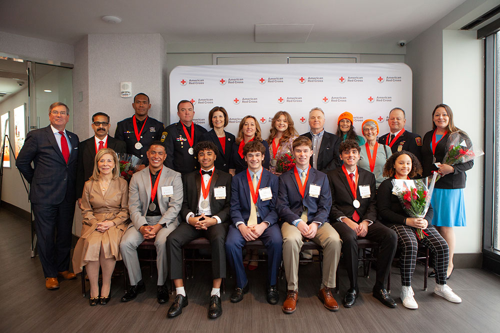 Group photo of 2024 Class of Heroes wearing their medals