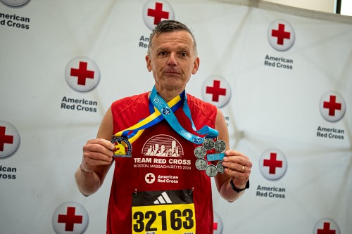 team red cross participant with medal.