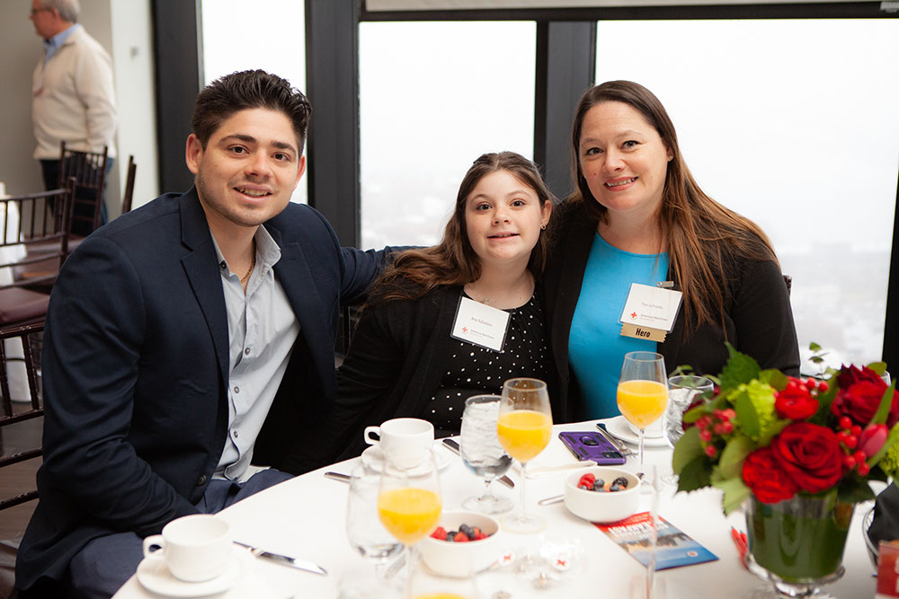 Nursing hero Tina LaTorella at event dinner table with famliy