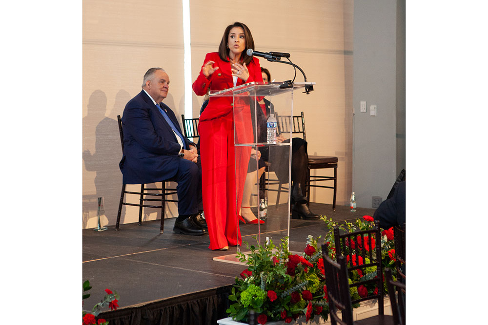 Woman on stage speaking at podium