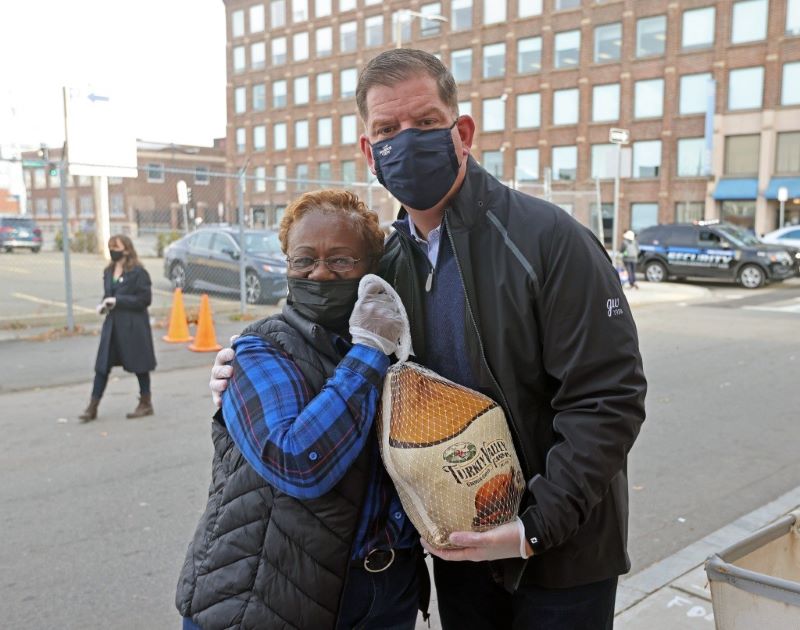 Sharon Curry helping at turkey drive with a man next to her