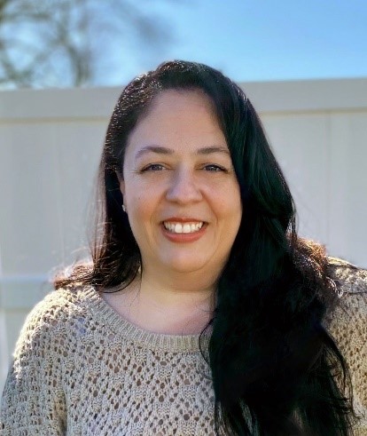 woman smiling in cram sweater