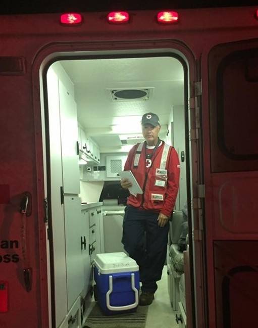 Red Cross volunteer Mark McLoughlin in the back of a Red Cross emergency vehicle.