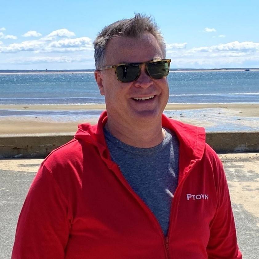Steven Latasa-Nicks wearing sunglasses and jacket with ocean in the background.