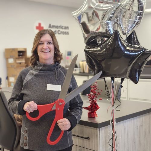 gail holding large ribbon cutting scissors