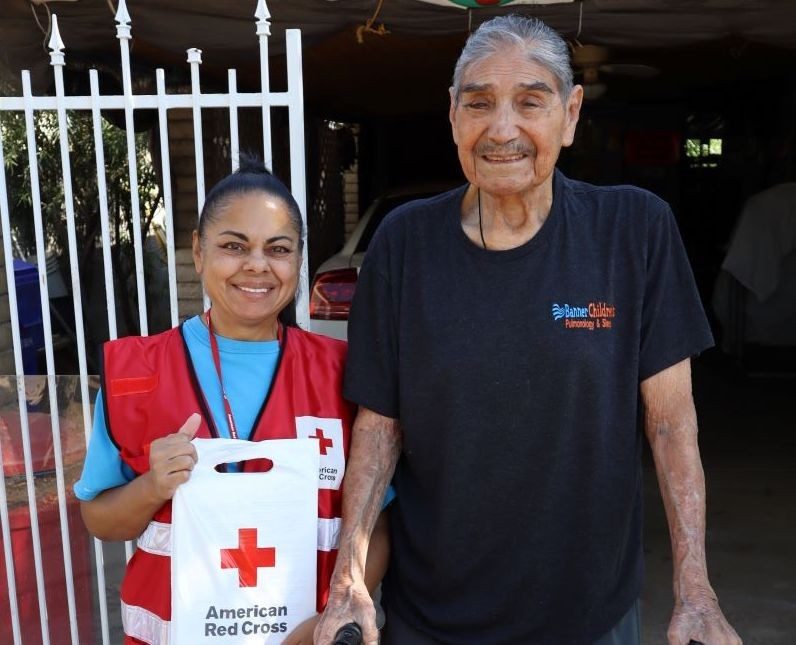Volunteer assisting an older man