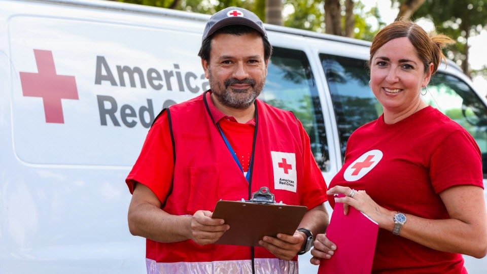 Red Cross volunteers standing next to each other