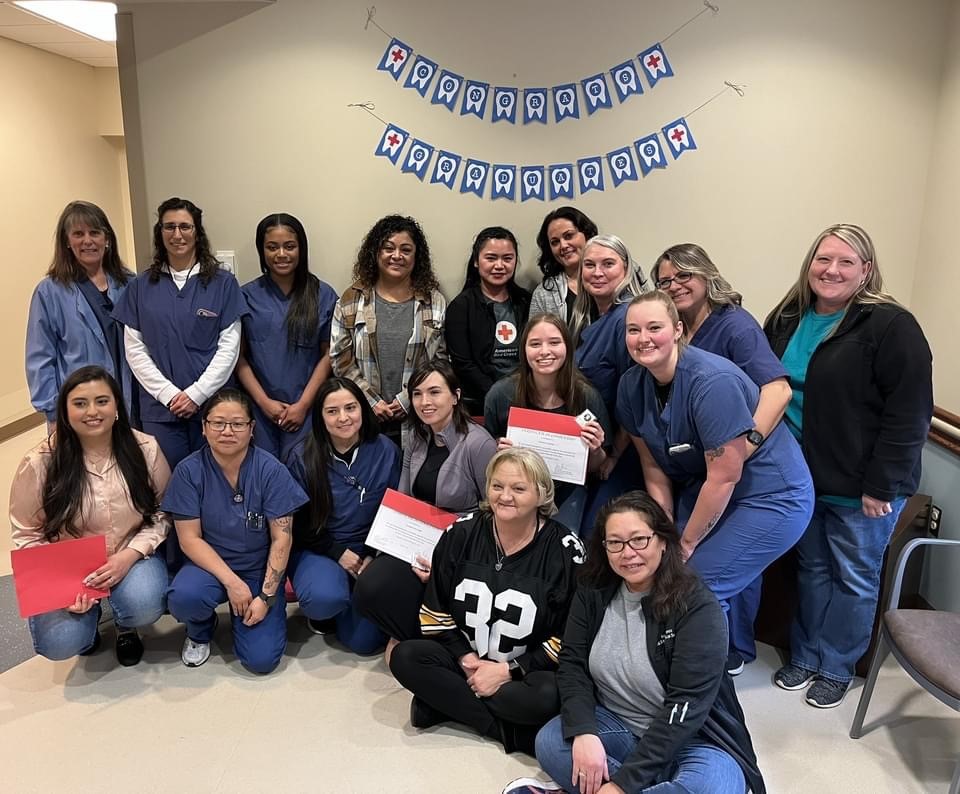 Past graduates of the dental assistant training program join recent graduates at Fort Leonard Wood, Missouri. The program is a partnership between the Red Cross and military. (Red Cross photo by Ann Vastmans)