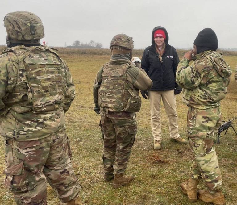 Jill Eaves, SAF regional program manager for the Red Cross Missouri-Arkansas Region, talks to American troops at a NATO training site in Poland where she was deployed. (Red Cross photo)