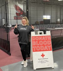 kate appleman in front of blood donation sign