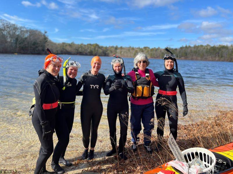 Susan and friends in scuba grear on a beach.