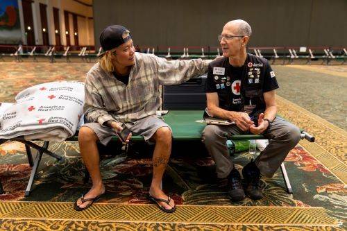 red cross client placing hand on shoulder of rich byam.