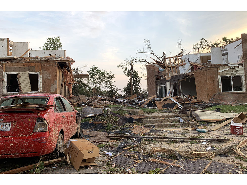 Houses and car damaged by tornado.
