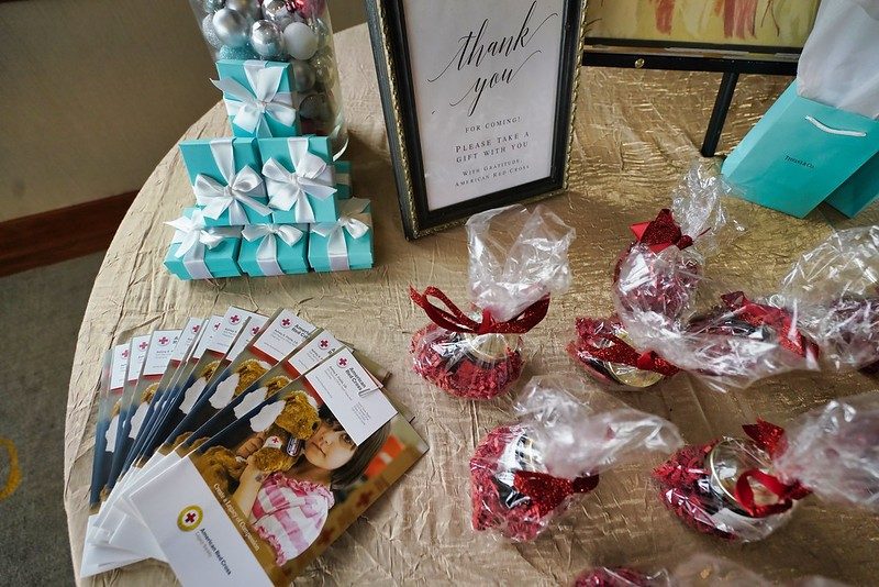 Table with gift bags and American Red Cross pamphlets.