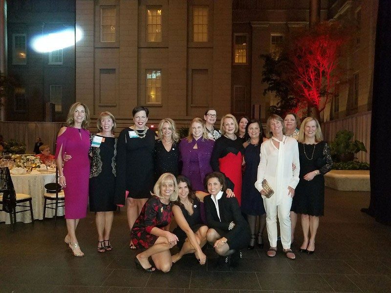 Group pic of Tiffany Circle members outside at night in lit area at Tiffany Circle Summit 2017.