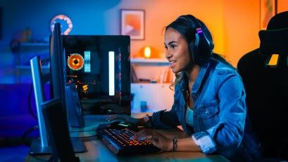 person sitting a computer playing video game