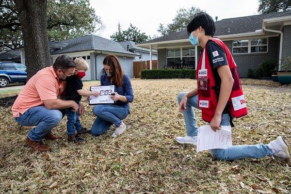 red cross volunteers discussing fire plan with clients