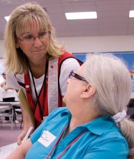 Sherri Odell chatting with a woman.