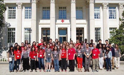 Group picture of IHL Youth Action Campaign members outside of a Red Cross building.