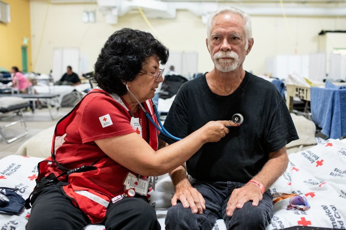 Kirk Herschell, being assisted by Disaster Health Services volunteer nurse Johanna Linnersten, lost everything when the storm surge from Hurricane Helene inundated his home.