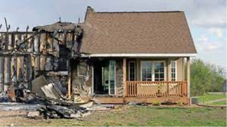 A home with major damage from a wildfire