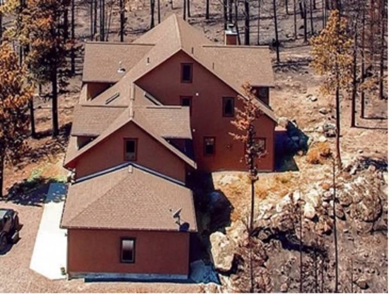 A single-family home with minor wildfire damage