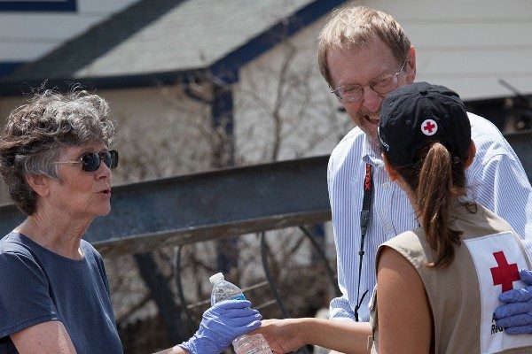 A Red Cross volunteer with a family after a home fire